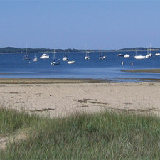 Beach shoreline with boats in distance