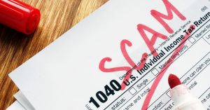 IRS form 1040 with red SCAM written in marker across the top