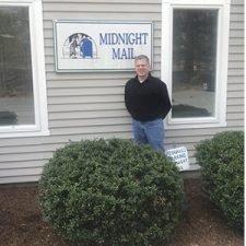 Midnight Mail owner, Ron Johnson, standing in front of business