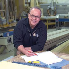 Wayne Paciocco, owner of Triple Crown Cabinets and Millwork in Sandwich poses in his woodworking shop