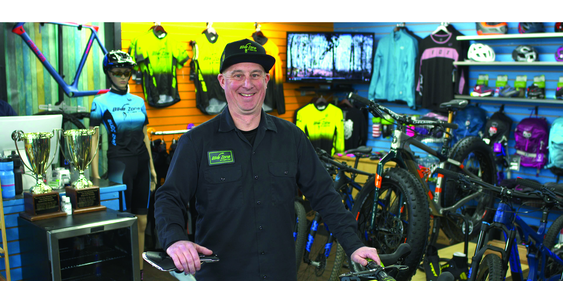 Bike Zone of Cape Cod owner, Tim Alty, stands in his shop with a bike