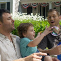 Image of family using bubbles with child