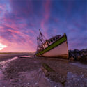 Image of boat in the ocean during low tide