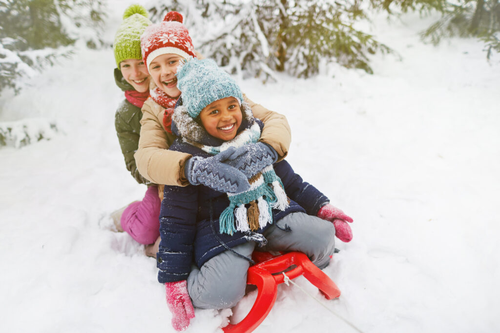 Three girls play in the snow