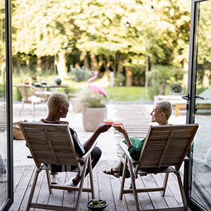 Young couple drinking cocktails at home terrace