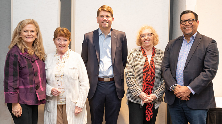 Lisa Oliver welcomes Patricia Nadle, from left, Matthew Cole, Carol Edmondson and Mario Campos to The Coop family during the Bank's Annual Meeting.