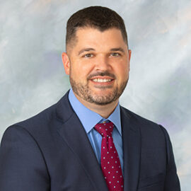 professional headshot of Erik Porter, Executive Vice President, Chief Financial Officer and Treasurer with The Coop