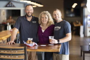 Allyson Brainson stands with Dan and Pat Smith, owners of Smith Family Beer Garden.