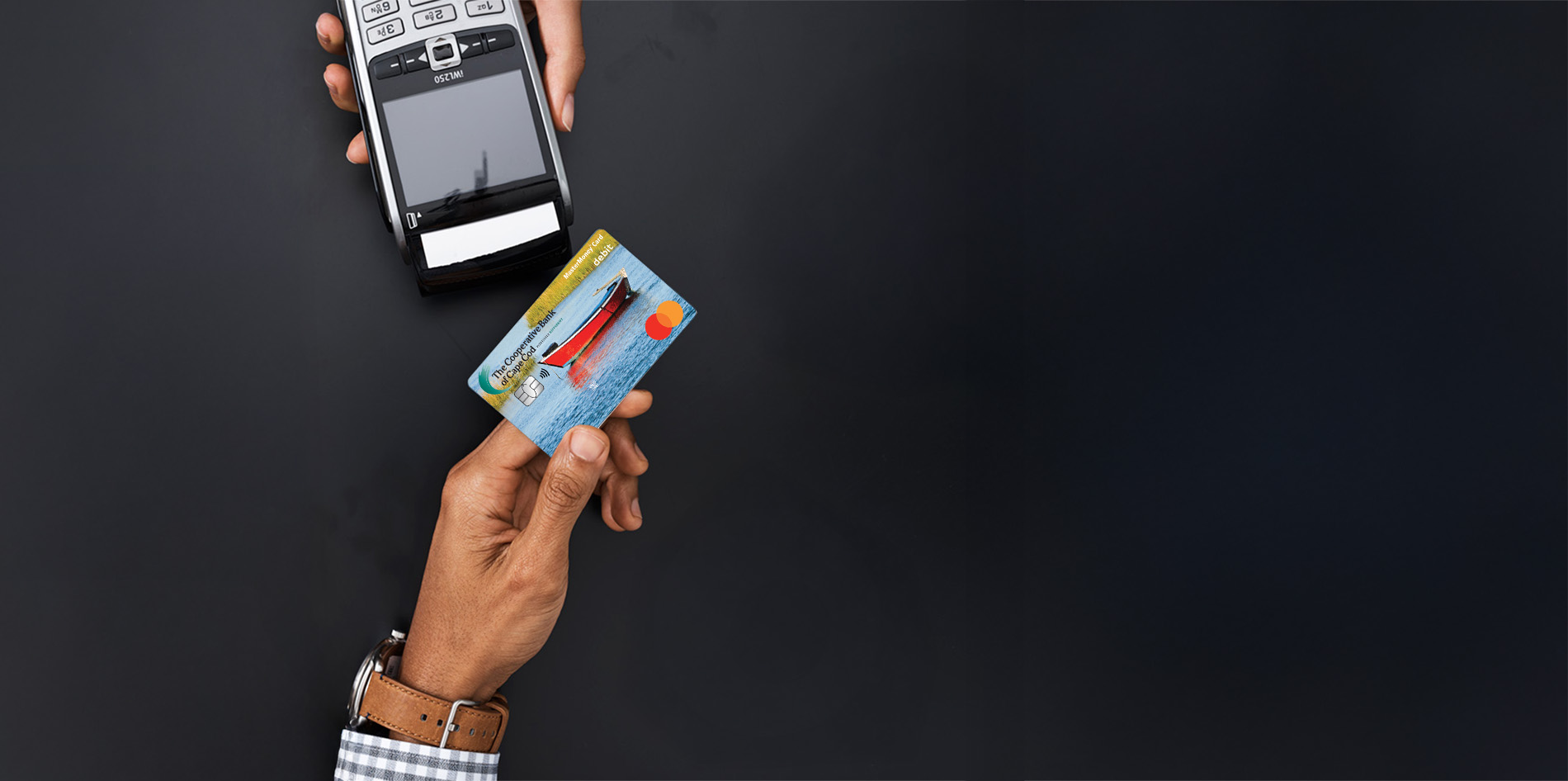 Person uses debit card to tap to pay